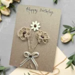 Beautiful Birthday Card For Wife. Handmade Greeting Card For Her showing three flowers made of wood, cotton string and coffee beans.