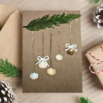 Beautiful Handmade Xmas Card adorned with seashells is seen hanging on a green bench.