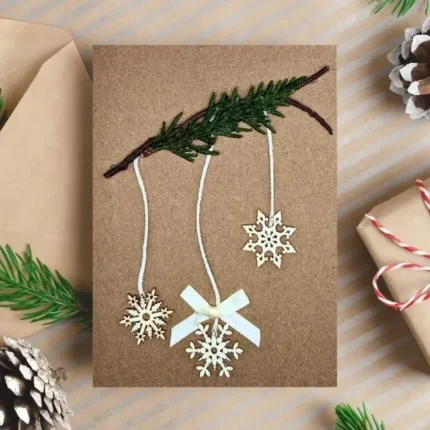 Beautiful Handmade Xmas Card adorned with snowflake hanging on a green bench.