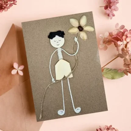 A Best Happy Mother's Day Card featuring a boy holding a flower made from pistachio shells.