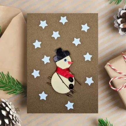 Easy Handmade Christmas Card decorated with a skiing snowman and stars. Made in the UK.