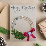 Fabulous handmade Christmas card with festive wreath, star, red ribbon, and text Happy Christmas.