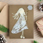 Handmade Christmas Card for Grandparents with a smiling girl made from lace fabric holding a star.