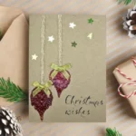 Handmade Heartwarming Christmas card adorned with dried leaves and stars, showcasing a handmade design.