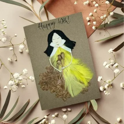 Handmade Personalised 40th Birthday Card for Her with Black Hairs made of yellow feathers and dry leaf.