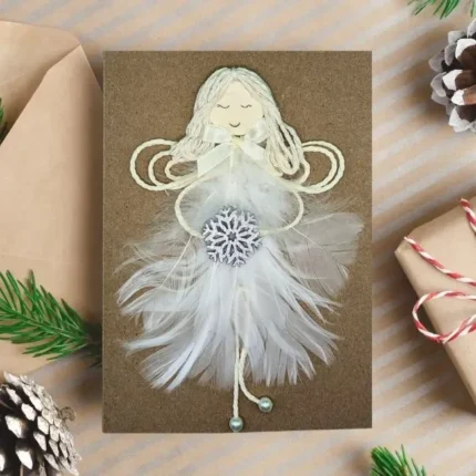 Beautiful Handmade Angel Christmas Card for wife featuring a girl made of a white feather, holding a wooden snowflake.