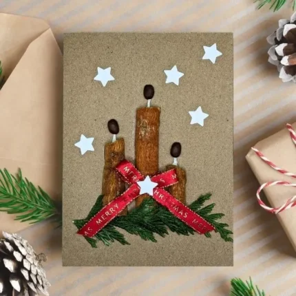 Handmade Christmas Greeting Card made of three cinnamon sticks and a red bow.