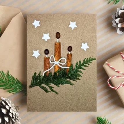Handmade Christmas Greeting card with three cinnamon sticks on a green branch.