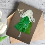 Perfect Birthday Wishes Card for Your Wife made of green feathers and wooden butterfly.
