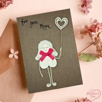 Perfect Cute Homemade Card for Mother from Her Daughter made of wood, red bow and cotton string on brown paper.