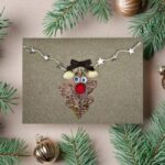 Handmade Funny Christmas Card for Family featuring a reindeer made of dried leaves and pistachios, surrounded by glowing stars.