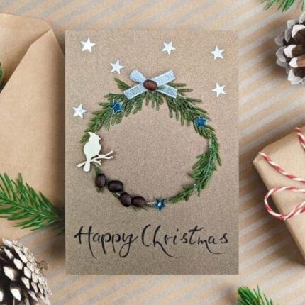 Personalised Handmade Christmas card on brown paper, with festive wreath, silver ribbon bow and bird.
