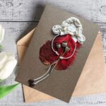 Romantic handmade love card for wife made of red feathers.