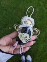 The Best Shell Angel Ornament hold in hand. Made with small dark seashell and wooden heart. She