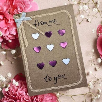 Elegant handmade Valentine's card with purple and white paper hearts. Made in Bollington, UK.