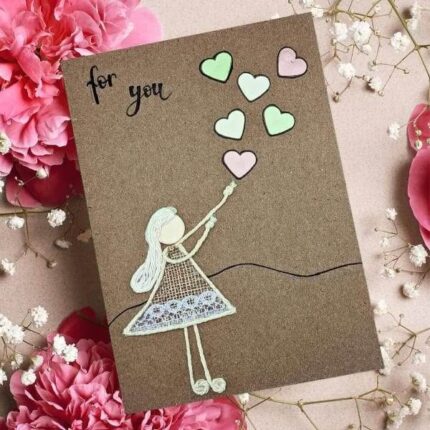 Homemade Personalised Valentines Card for Him featuring a woman releasing paper hearts.